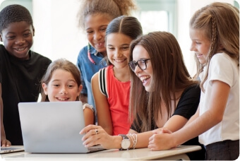 Children crowded in front of a laptop