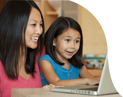 Mom and daughter looking a laptop smiling and surprised