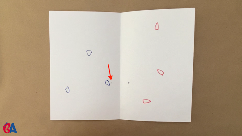 Drawing small blue and red boats on each side of a folded paper
