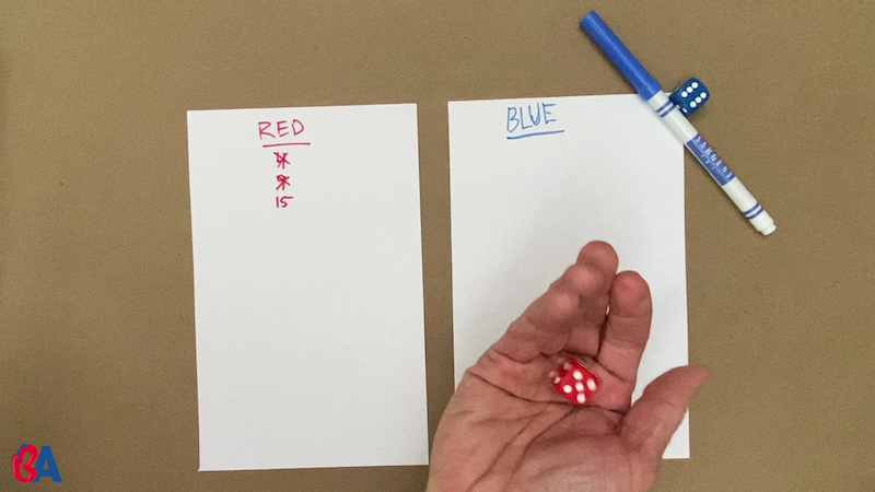 Two pieces of paper with names written at the top in red and blue. Red has some numbers written down.