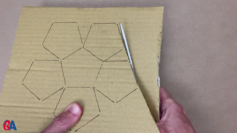 Cutting out the pentagon shapes